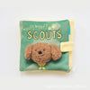 A soft green fabric toy with yellow trim and text that reads Woof woof Scouts