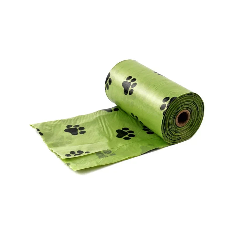 A roll of green heavy duty dog poop bags with black paw prints.