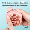 A hand is holding a pink silicone pet bath brush with bristles, demonstrating deep cleaning for pets.