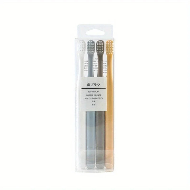 A clear plastic package containing a set of four toothbrushes and a travel case.