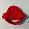 A bright red, chunky knit beanie hat designed for small dogs.