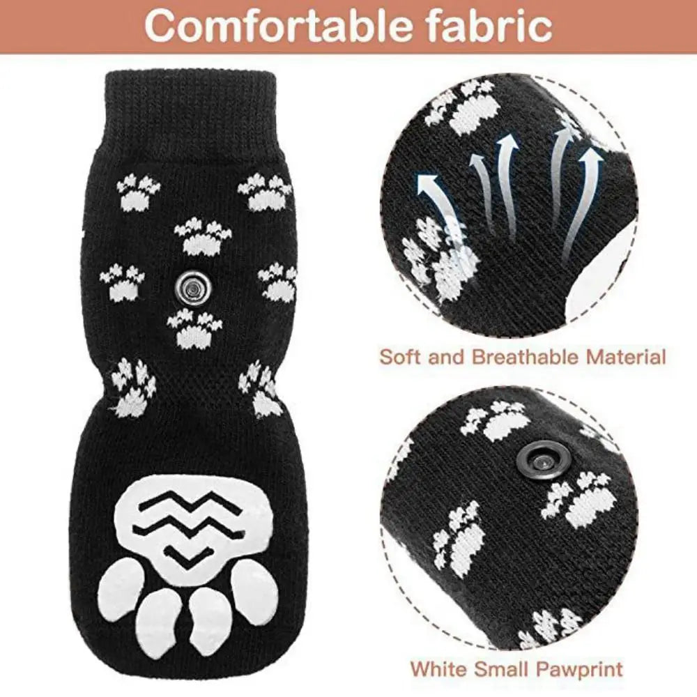 Black knitted dog socks with a white pawprint design showing the sole and toe area.