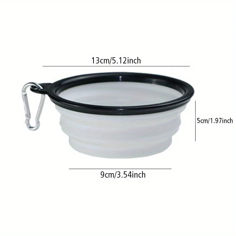 A white silicone dog travel bowl with a black rim and a metal clip.