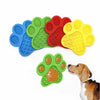 A set of silicone pet licking mats in various colors, including blue, green, red, and yellow, shown next to a dog's head.