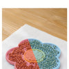 Silicone lick mat showing food in different colored silicone dishes for dogs and cats