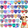 A set of colorful tie-dye pet accessories, including hexagonal tags and a heart-shaped collar, displayed on a dog.