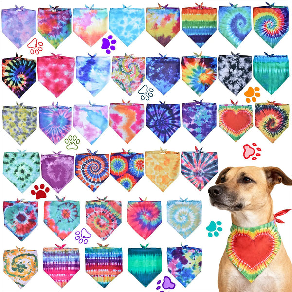 A set of colorful tie-dye pet accessories, including hexagonal tags and a heart-shaped collar, displayed on a dog.