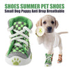 A light-colored puppy is wearing green and gray breathable anti-slip dog shoes.