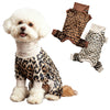 A fluffy white dog wearing a leopard print pajama set with brown accents.
