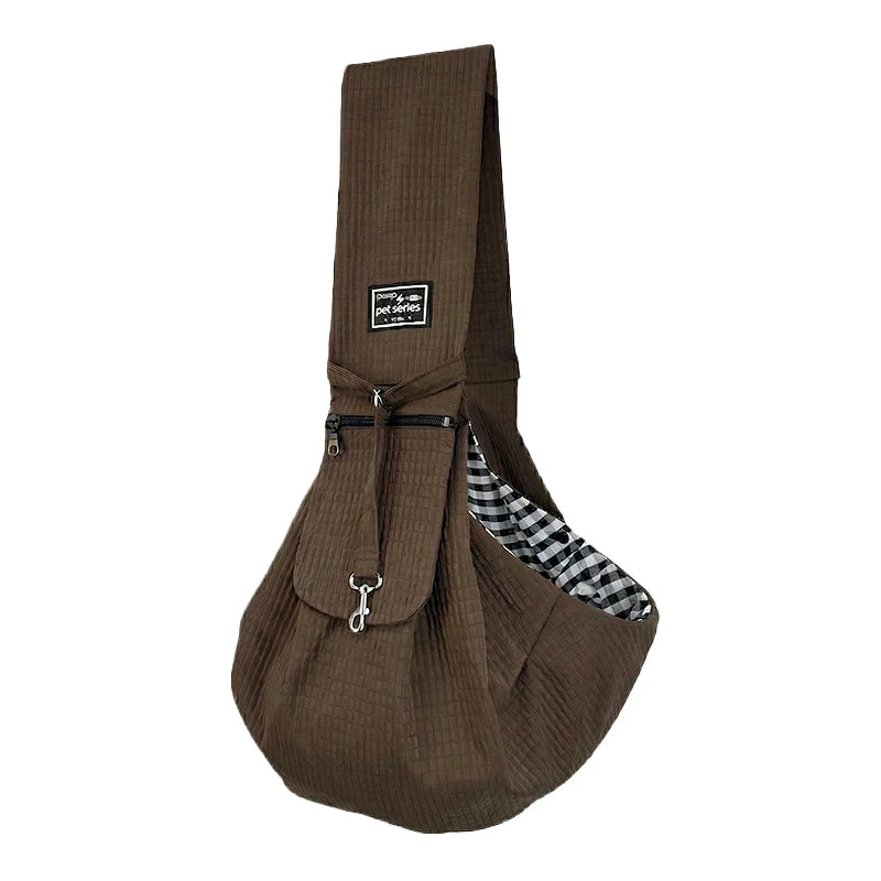A dark brown quilted crossbody pet carrier bag for dogs and cats.