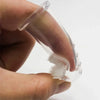 A hand holds a clear silicone finger toothbrush designed for gentle dental care.