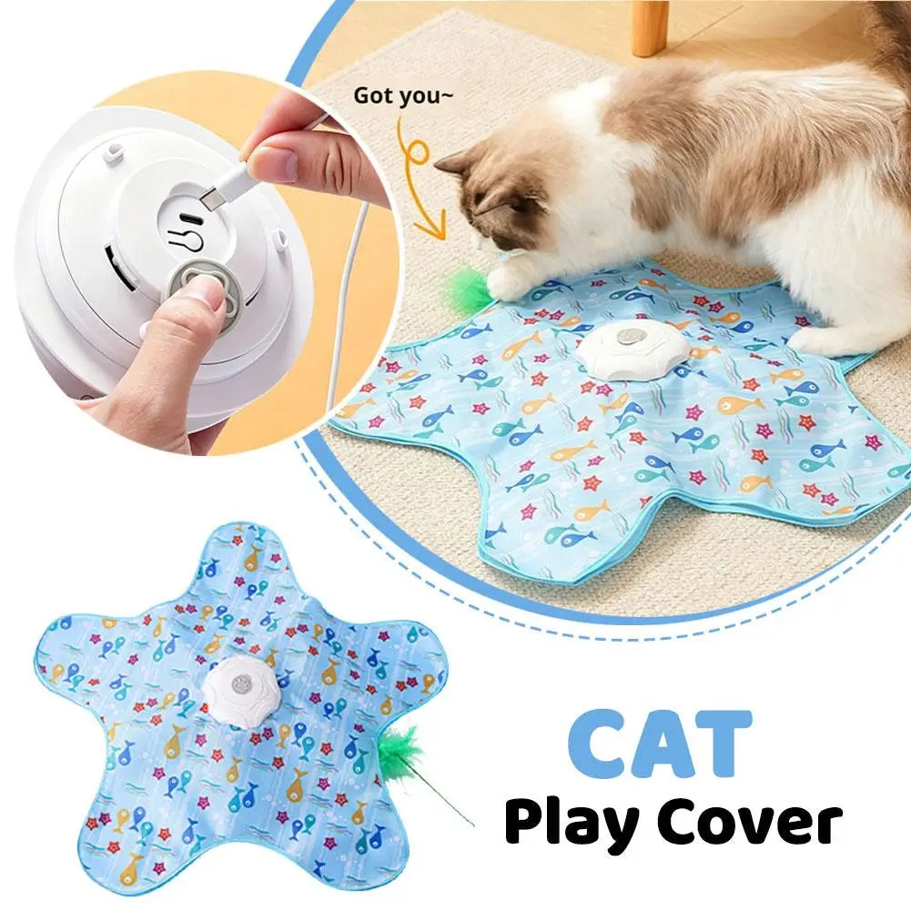 A blue cat play cover is shown with a cat lying on it, and a hand is shown using a white tool to interact with the toy.