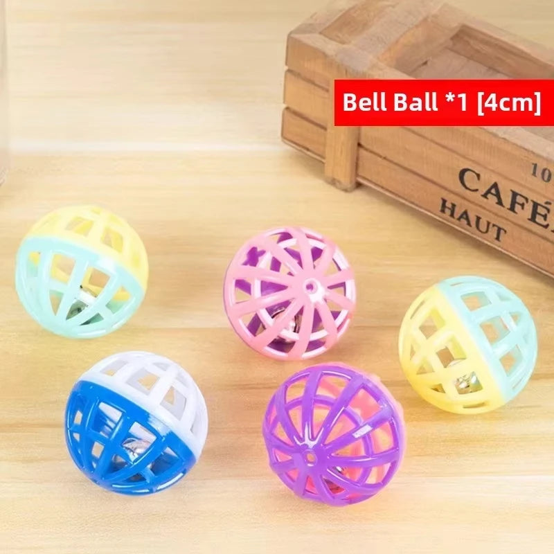 Five colorful ball toys, including yellow, pink, blue, and white, are displayed on a wooden surface.