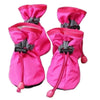 Pair of bright pink cozy anti-slip dog booties with black reflective grips