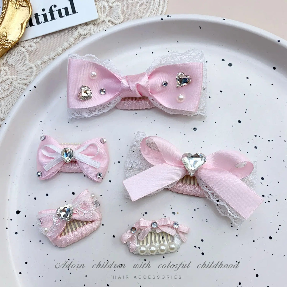 Pink bow hair accessory featuring pearl and rhinestone accents for children's hair