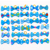 A collection of colorful pet hair bows in various patterns and colors attached with gentle rubber bands.
