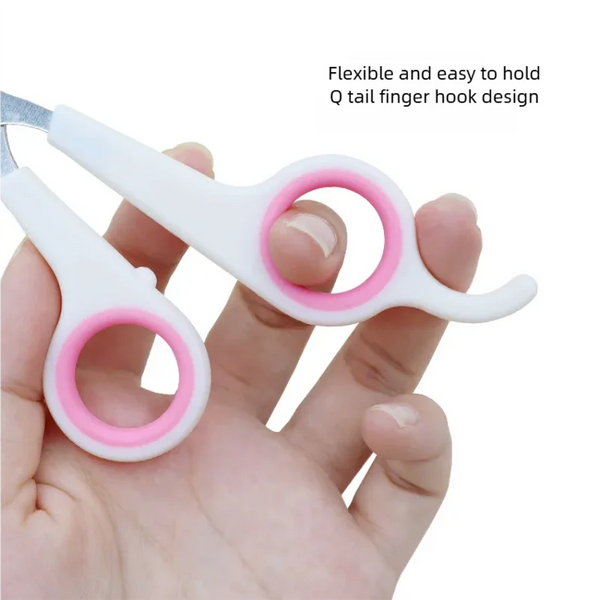 A hand holds a white and pink Q tail finger hook design pet nail clipper tool.