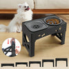 A black adjustable elevated dog bowl stand with anti-slip feet is shown next to a white dog and various sized bowl holders.