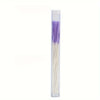 A clear plastic container filled with a set of purple and white disposable ear cleaning tools.