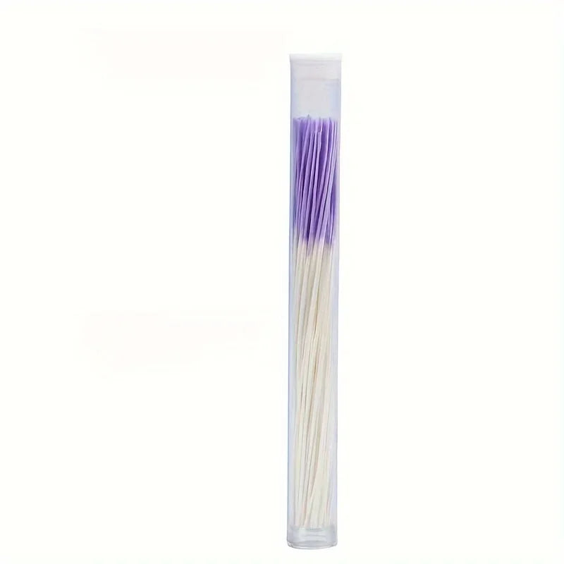 A clear plastic container filled with a set of purple and white disposable ear cleaning tools.