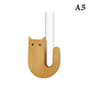A wooden cat-shaped vase with a white cylindrical neck.