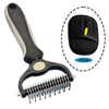 A black pet grooming brush with a handle and a flexible metal comb, shown next to a black cleaning pad.