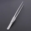 Stainless steel aquarium cleaning tweezers shown diagonally on a dark gray surface.