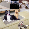 A reusable pet training pad is shown with a dog and a cat resting on it, alongside fabric and a white device.
