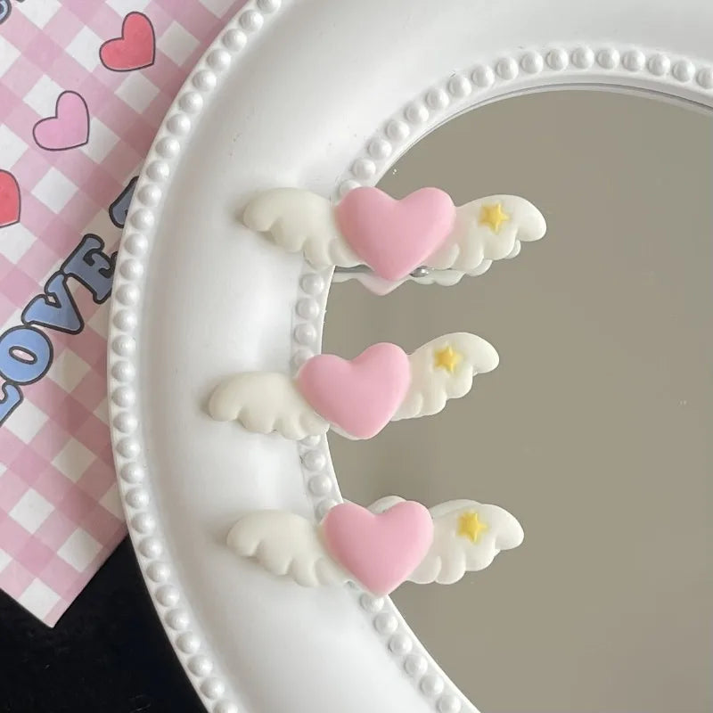 Three heart-shaped mini pet hair clips in pink and white are displayed on a white dental tray.