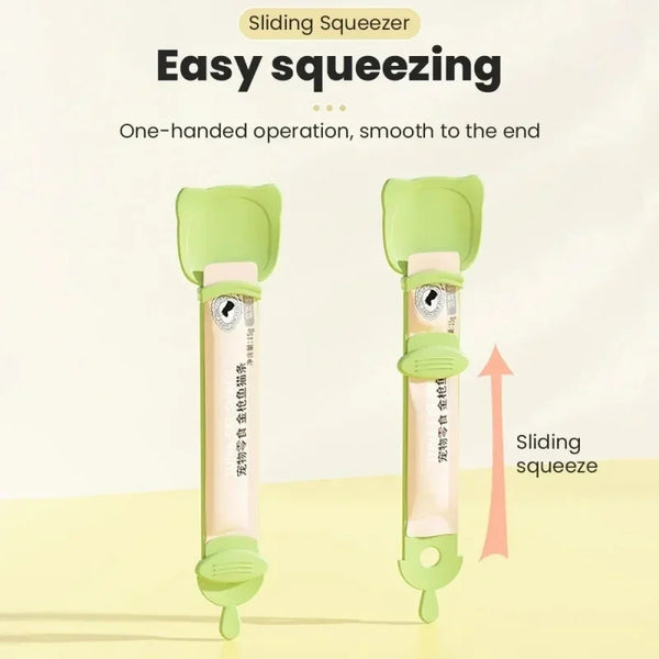 A light green sliding squeezer tool with a long handle and a pink food pouch, demonstrating an easy squeezing operation.