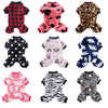 A collection of cozy winter overalls for small dogs in various patterns including plaid, pink, leopard print, and black polka