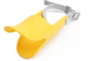 Yellow adjustable silicone duckbill dog muzzle with a gray strap