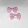 Ein Set aus drei rosa und weißen Puppenhund-Bow-Knoten für das Tierpflegegrooming.