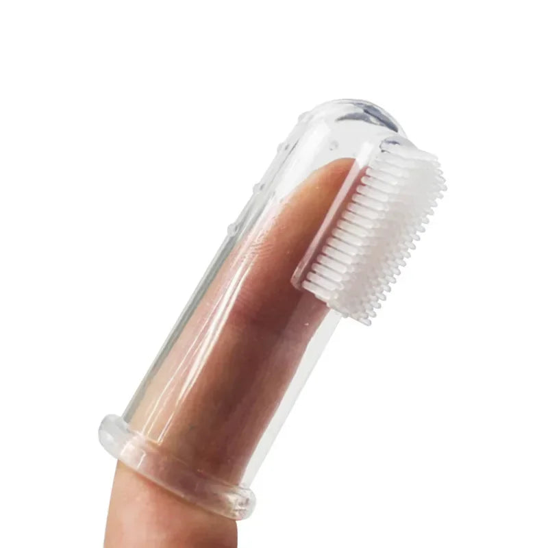 A hand holds a clear silicone finger toothbrush designed for dogs and cats.