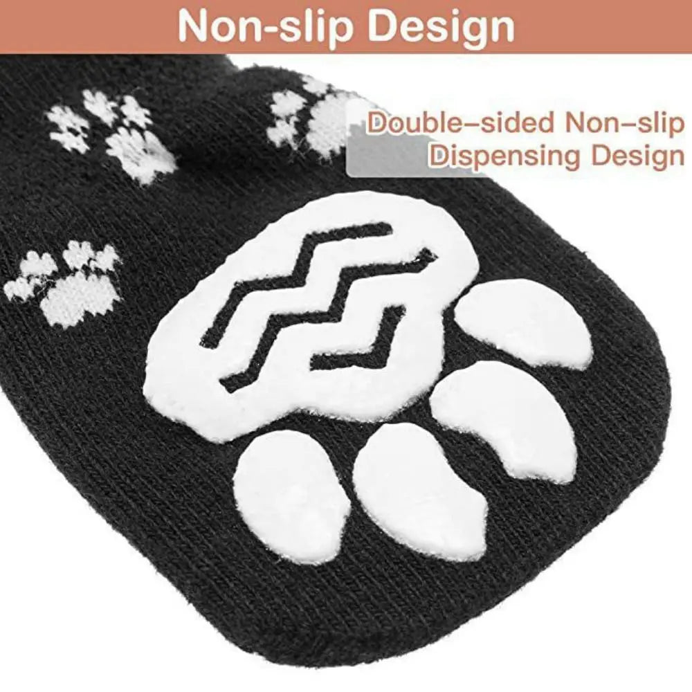 Black knitted dog socks with a white paw print design and non-slip grip