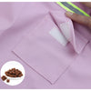 A pink waterproof reflective dog raincoat with a patch detail is shown on fabric.