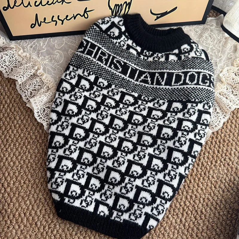 A black and white knit sweater featuring a repeating dog motif pattern.