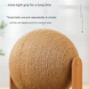 A round, textured brown wooden cat scratching toy with a wooden base.