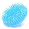 A light blue silicone hair and scalp massage brush with numerous fine, pointed bristles.