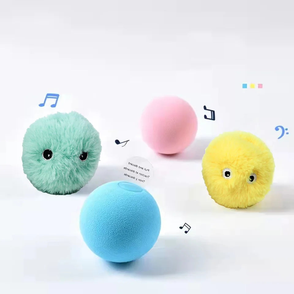 A collection of colorful, fuzzy, spherical interactive toys in green, pink, blue, and yellow with musical notes floating arou