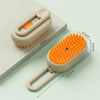 A beige pet grooming brush with a steam spray feature is shown on a light surface.