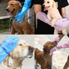 Hands wearing various colored grooming gloves gently holding and petting dogs.