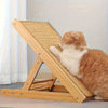 A fluffy orange and white cat is relaxing on a wooden sisal scratching post for scratching.
