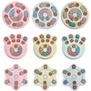 A collection of pink and light-colored interactive dog slow feeder puzzle toys with various patterns and shapes.
