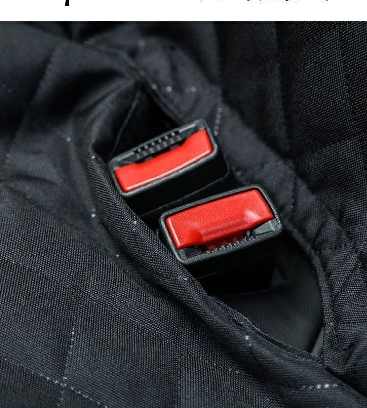 Close-up view of a black fabric dog car seat cover showing a red armrest access panel.