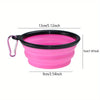 A bright pink silicone dog travel bowl with a black rim and a loop for carrying.