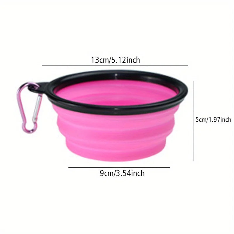 A bright pink silicone dog travel bowl with a black rim and a loop for carrying.