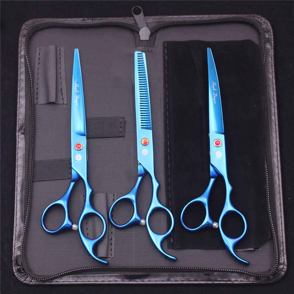 A set of professional stainless steel pet grooming scissors in blue housed in a black case.