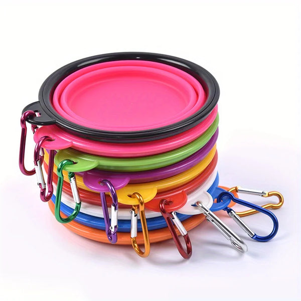 A stack of colorful silicone dog travel bowls with metal clasps, featuring pink, green, yellow, orange, and blue.