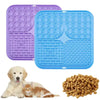 A set of purple and blue silicone lick mats for dog bathing and slow food training, next to a golden retriever and a cat.